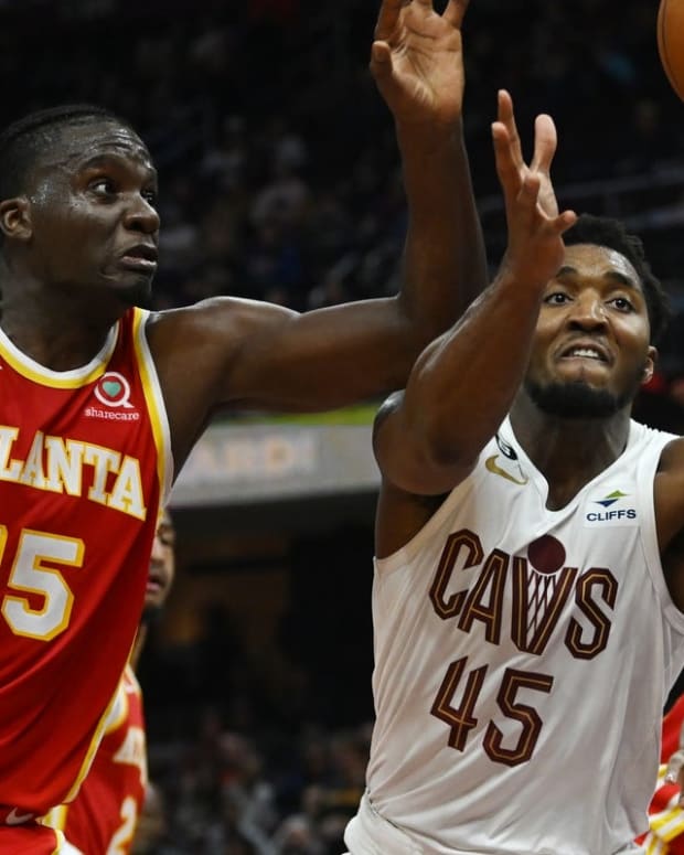 Oct 12, 2022; Cleveland, Ohio, USA; Atlanta Hawks center Clint Capela (15) and Cleveland Cavaliers guard Donovan Mitchell (45) go for a rebound during the second half at Rocket Mortgage FieldHouse. Mandatory Credit: Ken Blaze-USA TODAY Sports